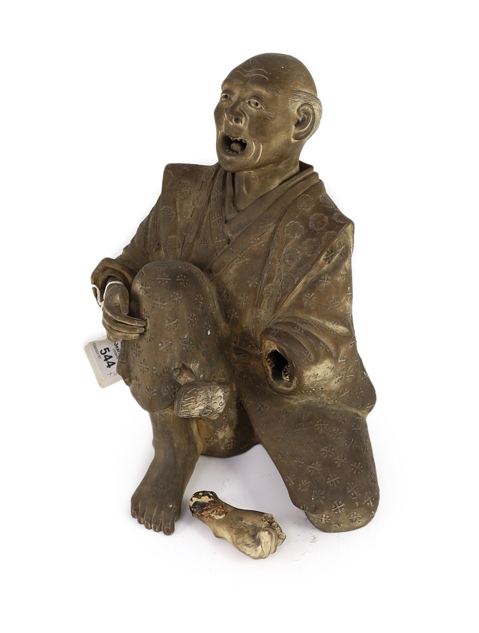 A Japanese terracotta figure of a kneeling and shouting man, 26cm high
